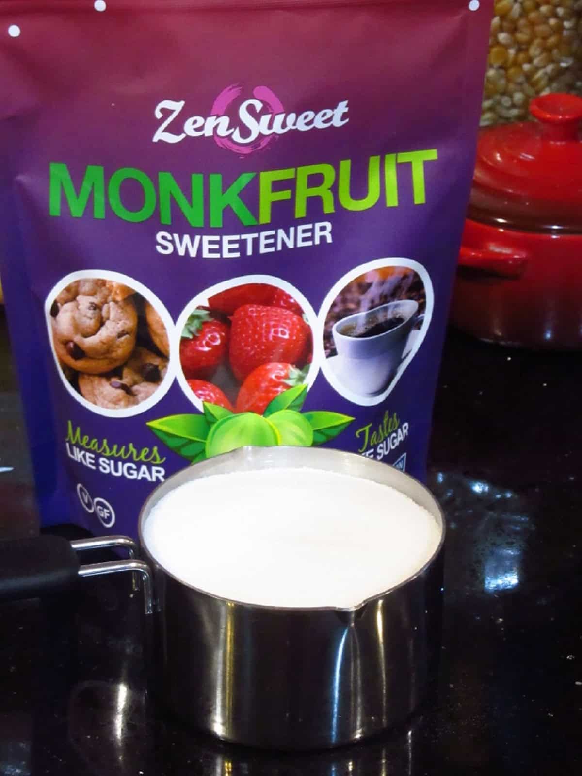 A bag of monk fruit sweetener and a measuring cup.