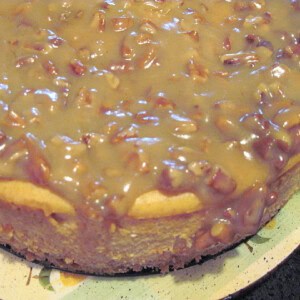A Maple Pumpkin Cheesecake with a maple nut glaze on a plate.