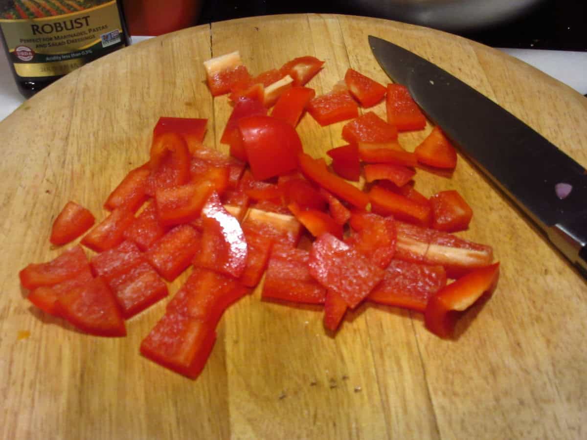 Chopped Red Peppers on a cutting board.