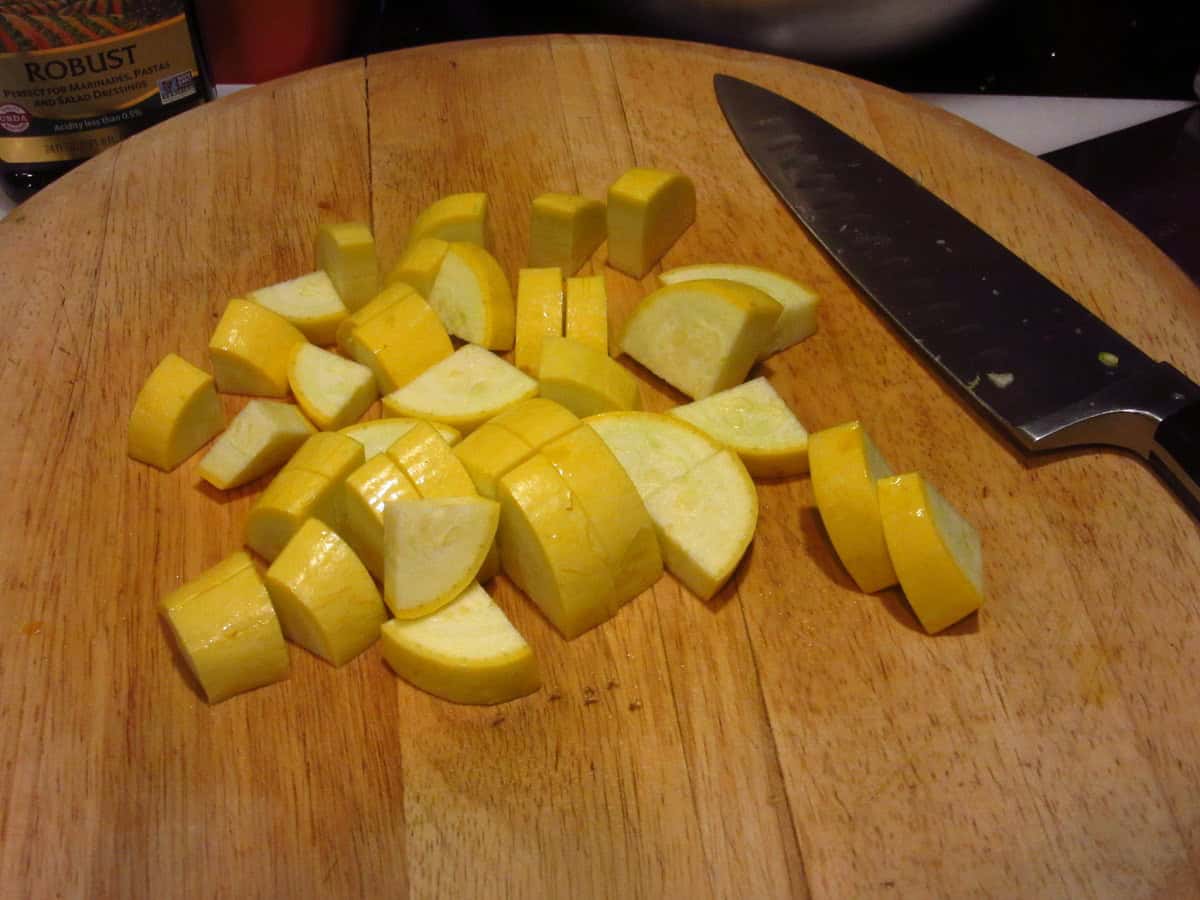 Chopped summer squash on a cutting board.