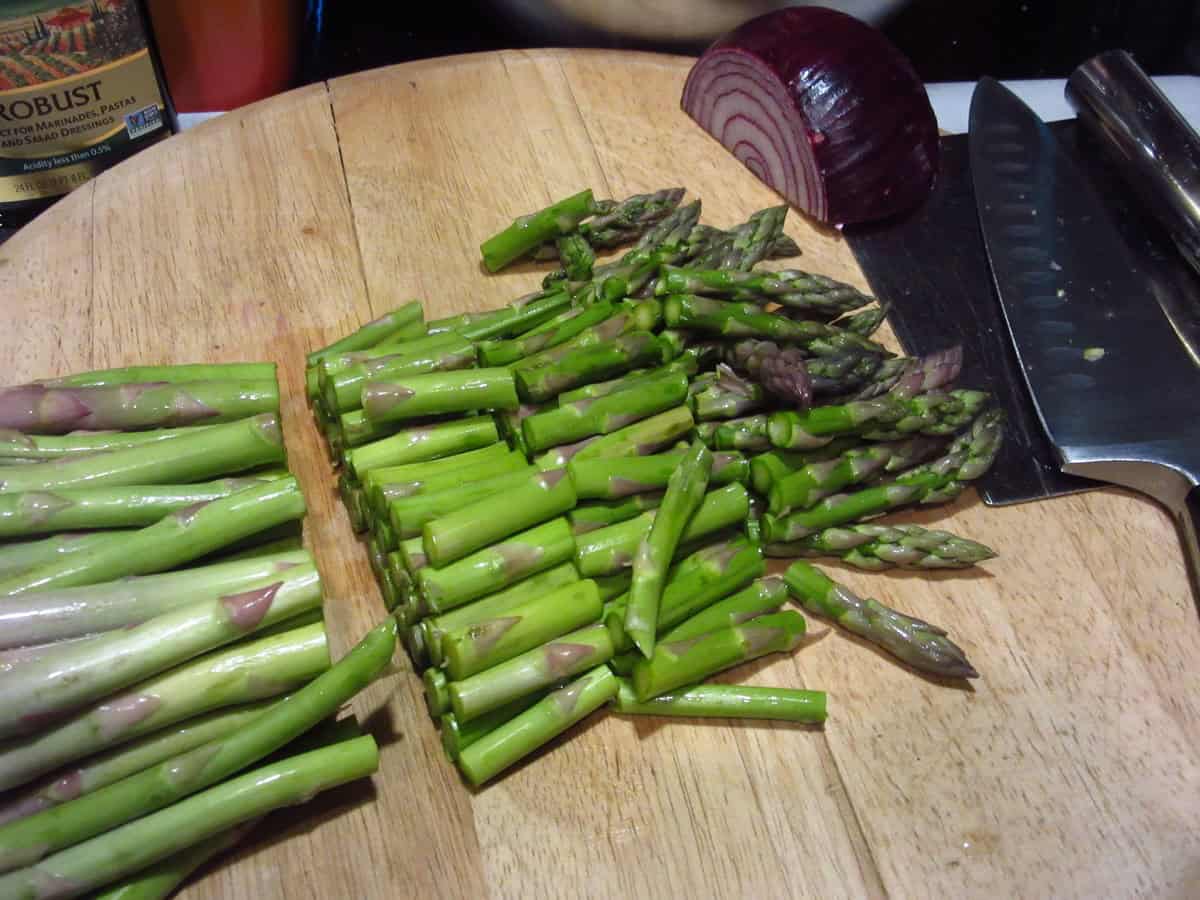 Chopped asparagus on a cutting board.