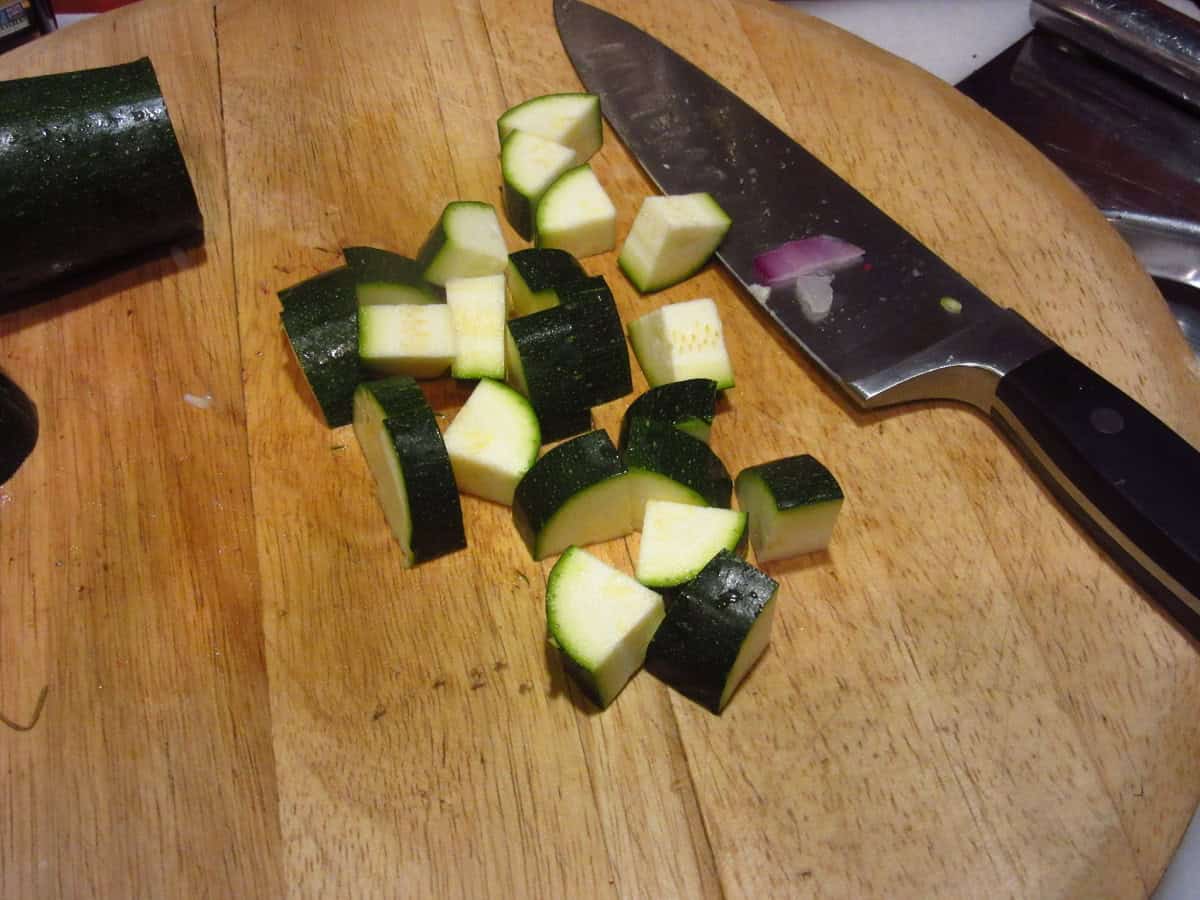 Chopped zucchini on a cutting board.