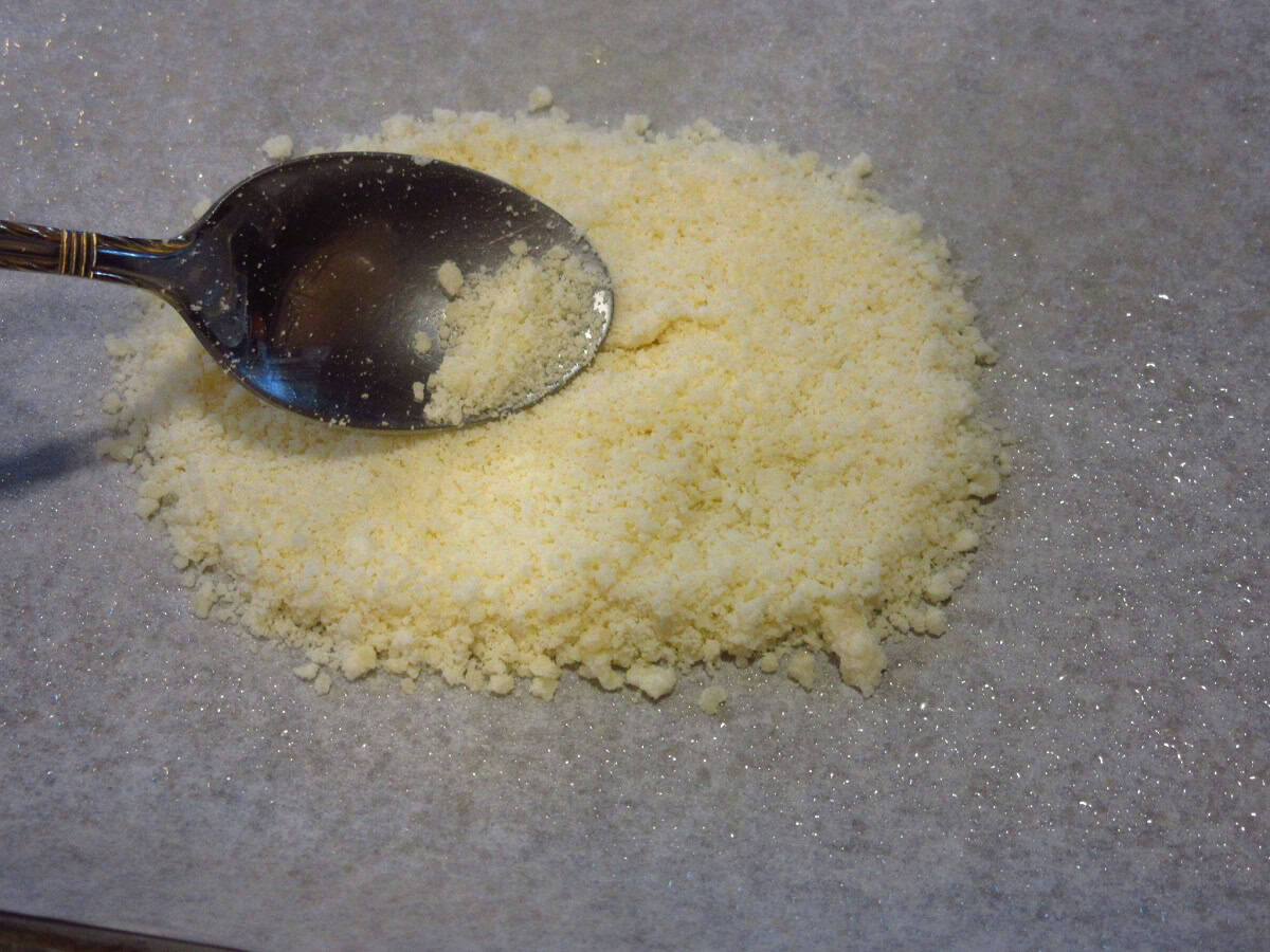 Grated parmesan cheese and a spoon.