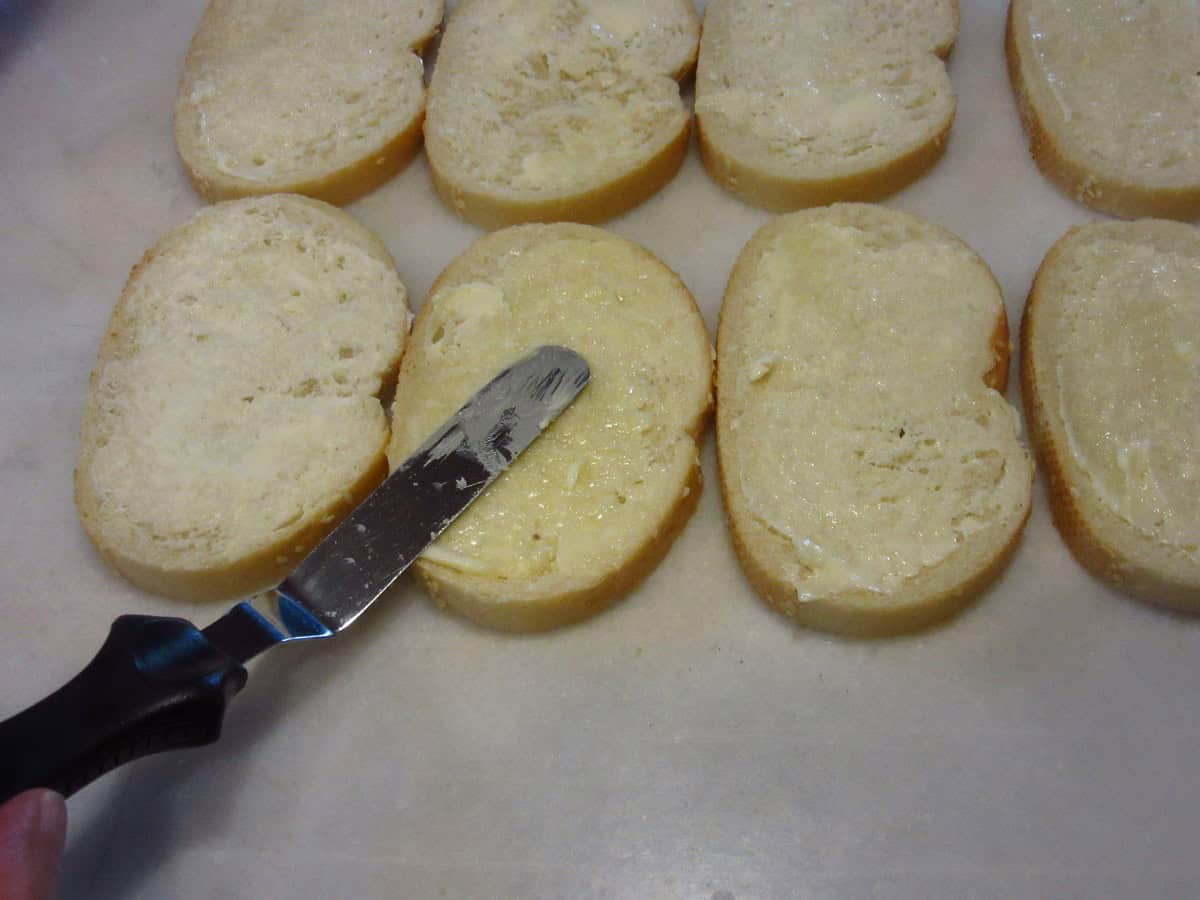 An offset spatula spreading butter on bread.