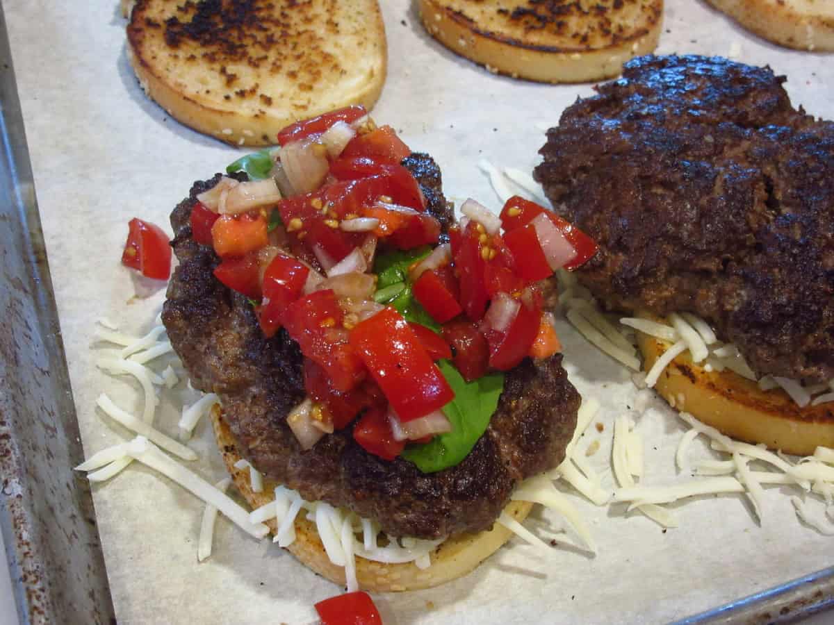 Tomato relish on top of a burger.