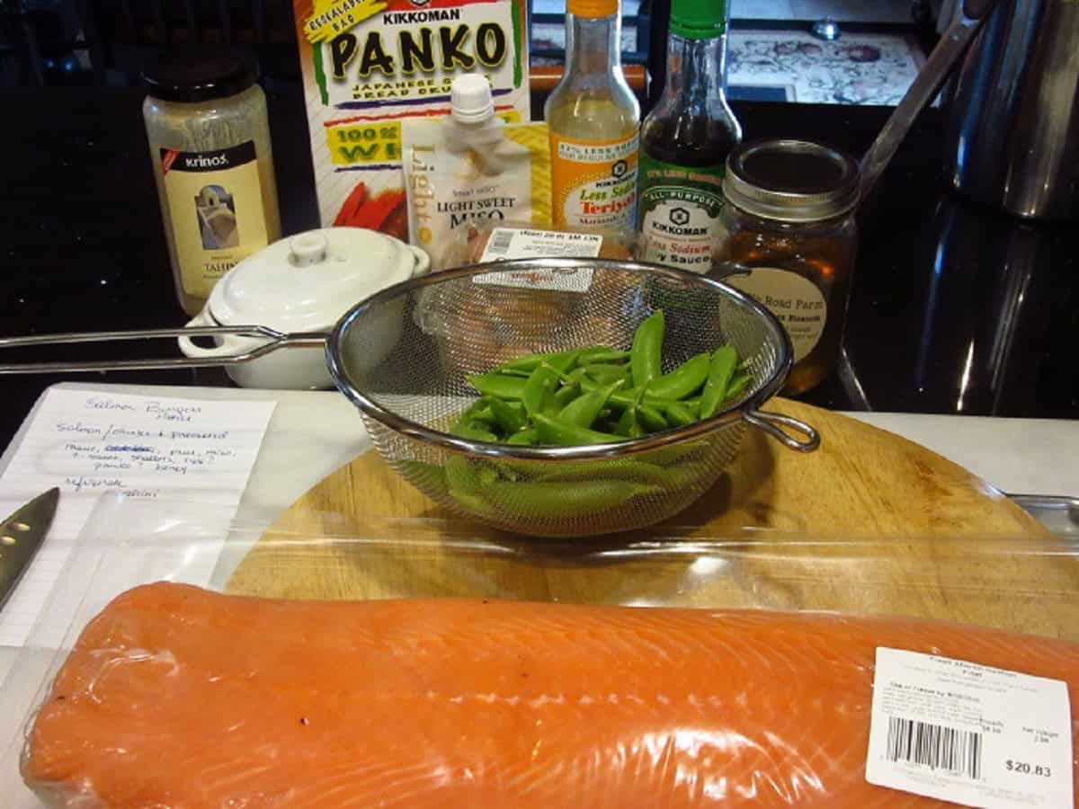Salmon and the ingredients to make salmon burgers.