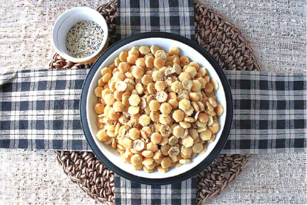 Crisscross black and white napkins with a black and white bowl on top holding Everything Seasoned Oyster Crackers.
