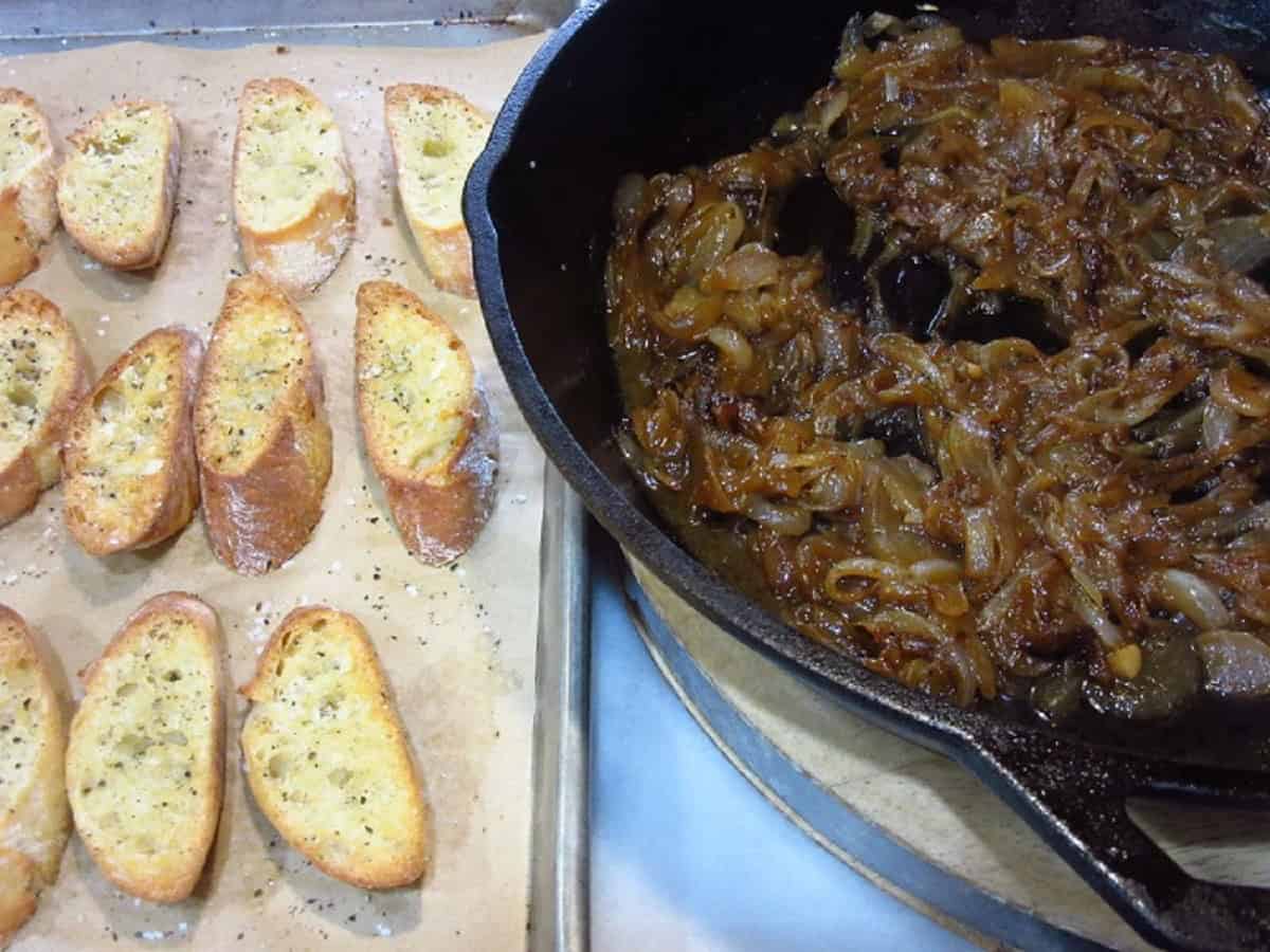 Toasted crostini slices and a skillet of caramelized onions.