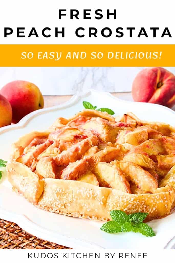 A delicious looking fresh peach crostata on a white plate with a sprig of mint.