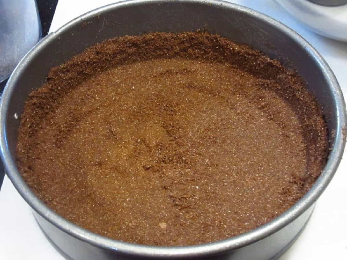 Chocolate graham cracker crust in a springform pan.