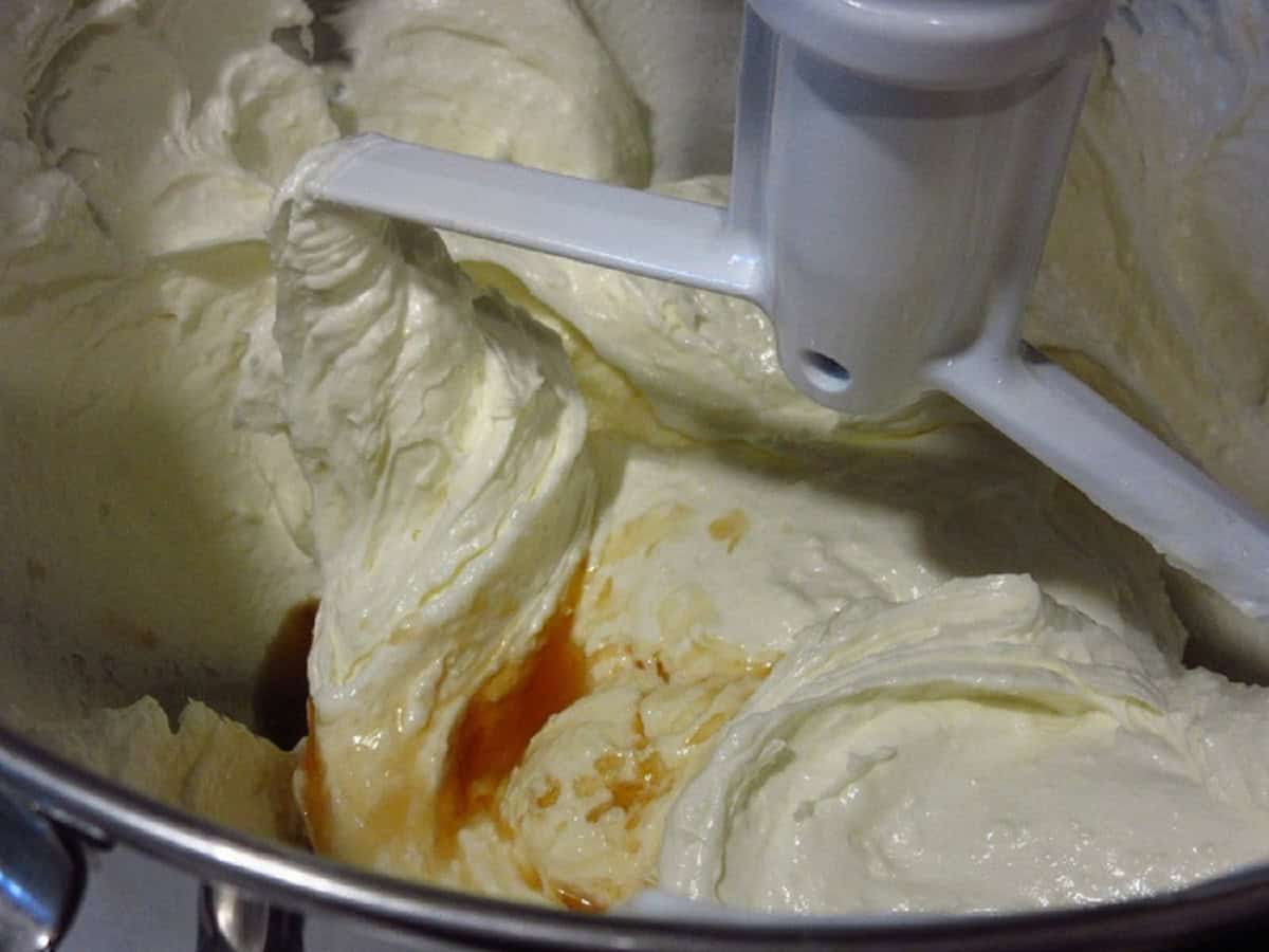 A creamy cheesecake batter in a stand mixer.