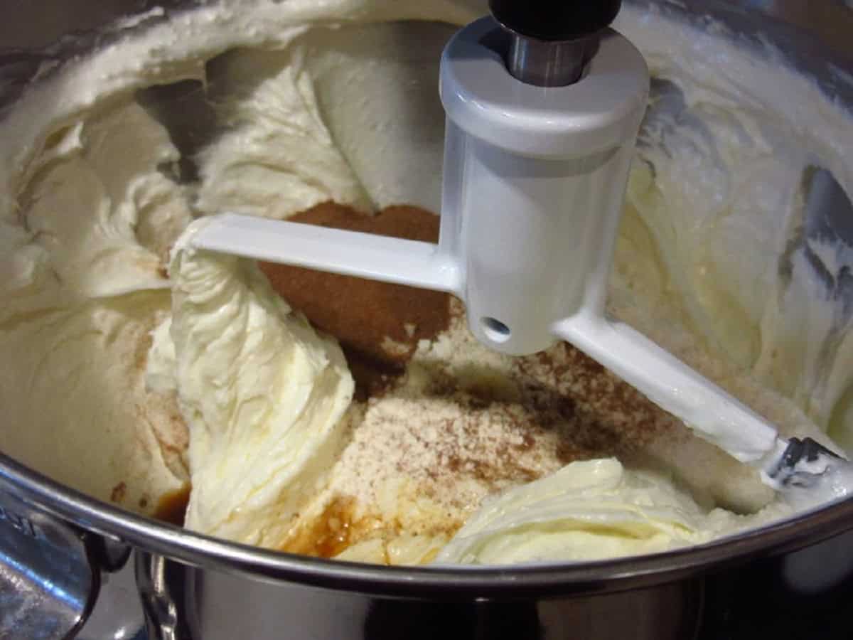 A cheesecake batter in a stand mixer bowl.