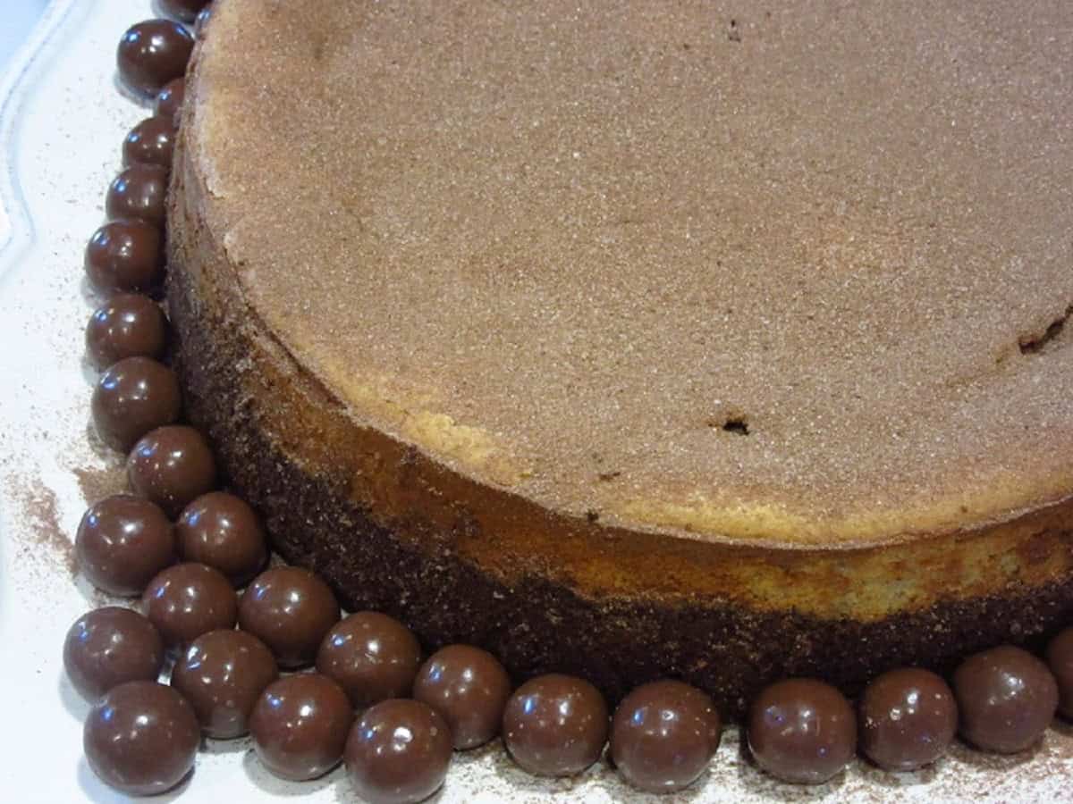 Malted milk powder dusted over a malted milk ball cheesecake.