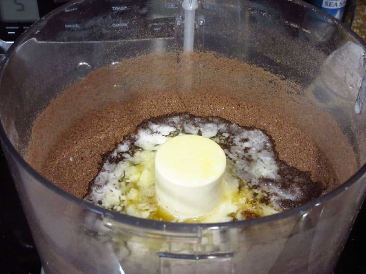 Melted butter and chocolate crumbs in a food processor.