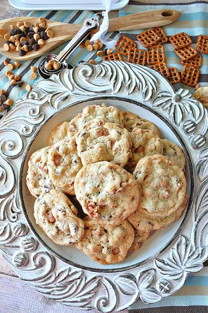 A plate full of Take 5 Cookies with pretzels, chocolate, peanut butter chips.