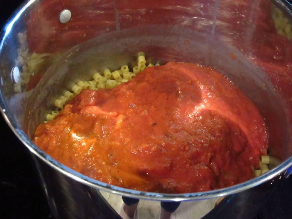 Mascarpone tomato sauce in a pasta pot with ditallini pasta.