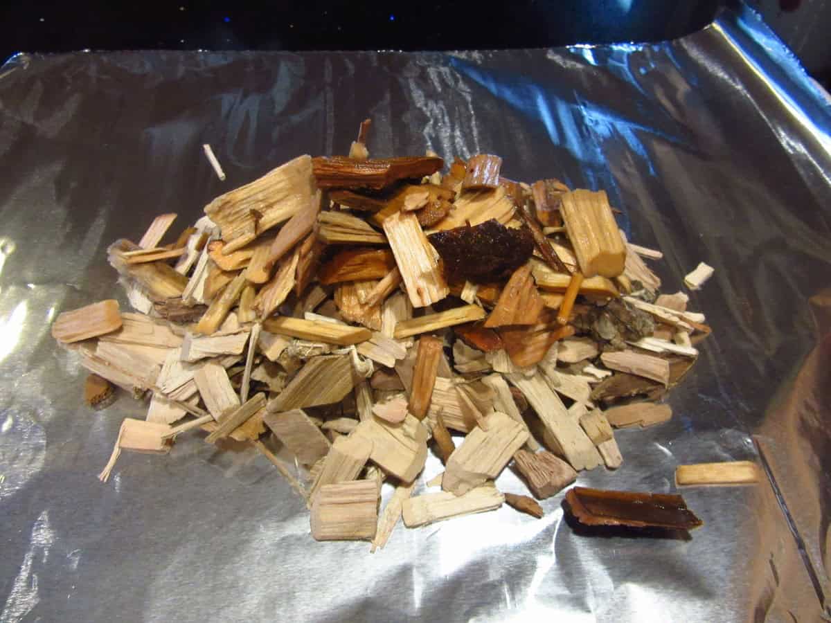 Wet wood chips added to a sheet of aluminum foil to turn an outdoor grill into a smoker.