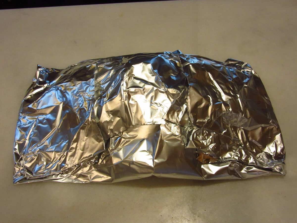 A packet of wood chips wrapped in aluminum foil to turn a grill into a smoker.