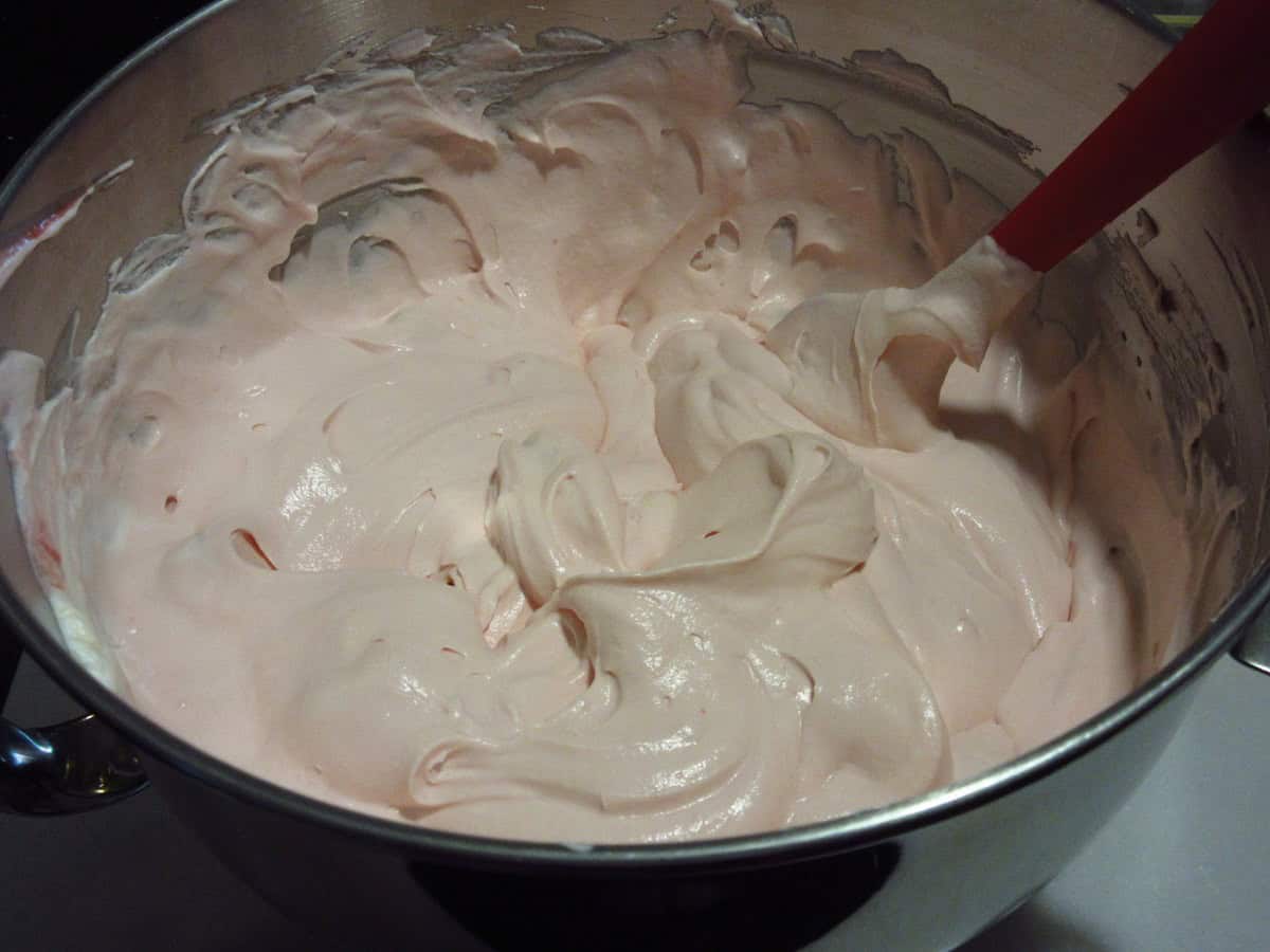 A pretty pink cherry amaretto ice cream base in a stainless bowl.