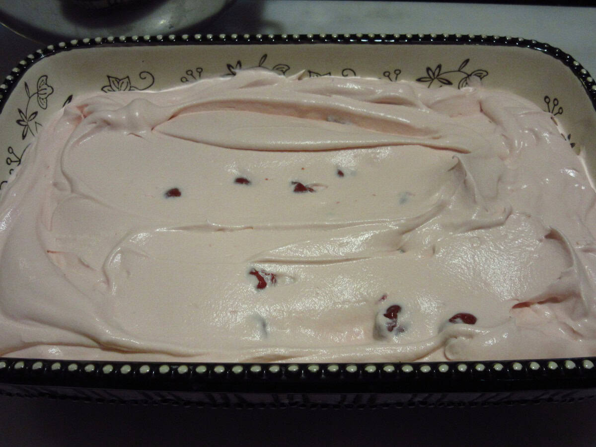 A smoothed cherry amaretto ice cream base in a ceramic dish before freezing.