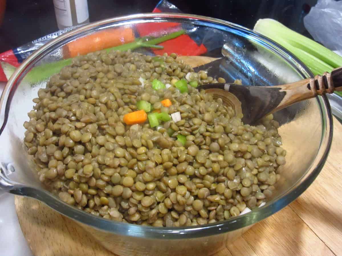 Lentils, carrots, and celery in a large glass bowl.