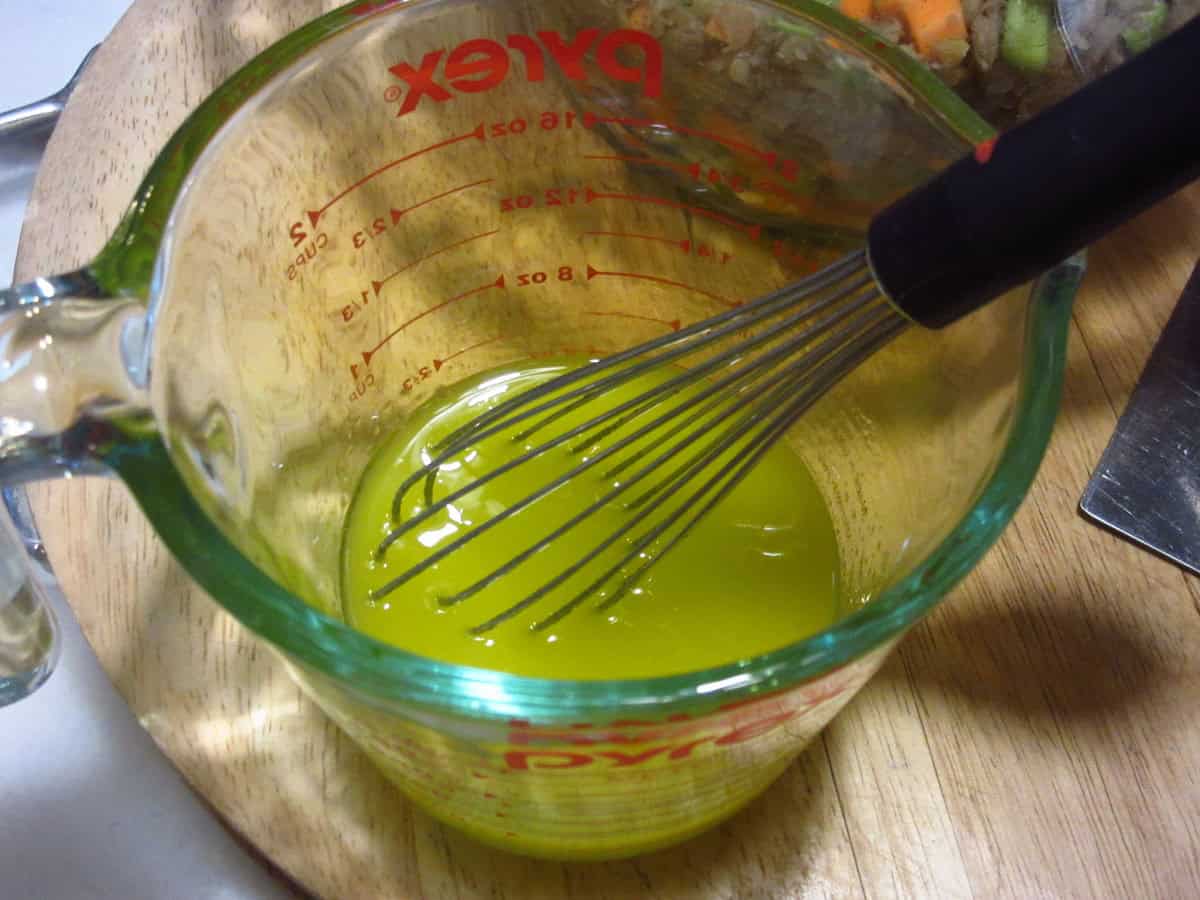 Olive oil in a glass measuring cup.