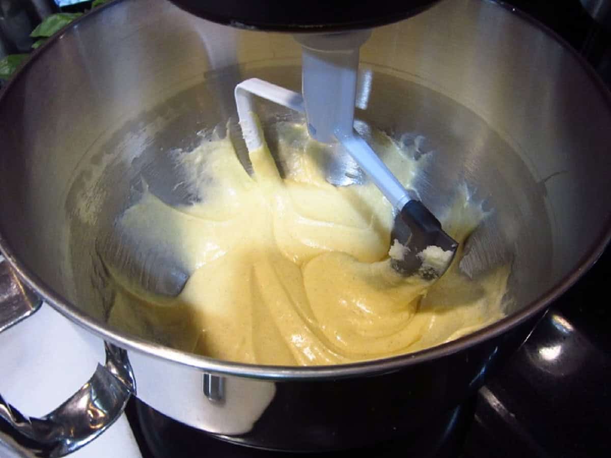Creamy batter in the bowl of a stand mixer.