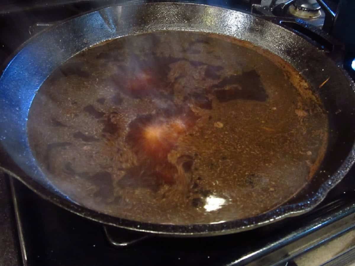 Beef stock in a cast iron skillet.
