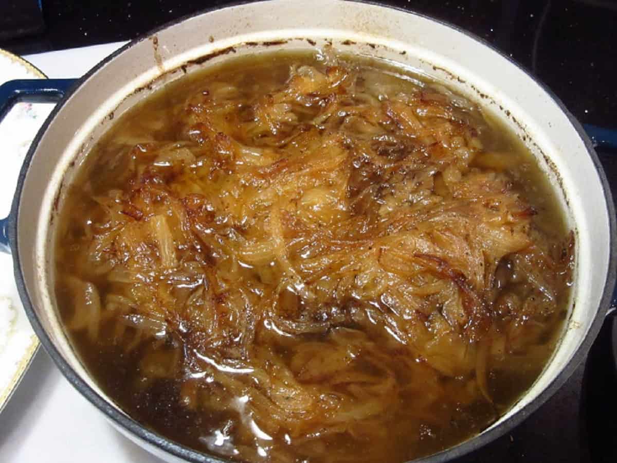 Caramelized onions in a Dutch oven with short ribs.