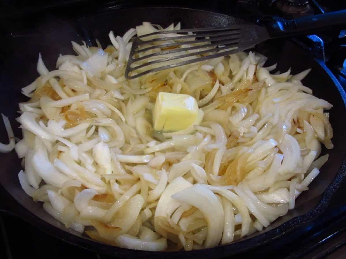 Butter in a skillet of browning onions.