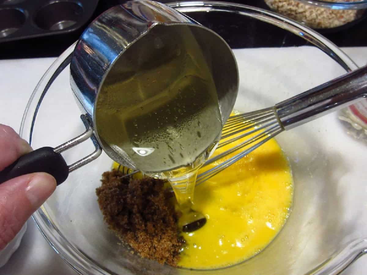 Corn syrup being added to a glass bowl.