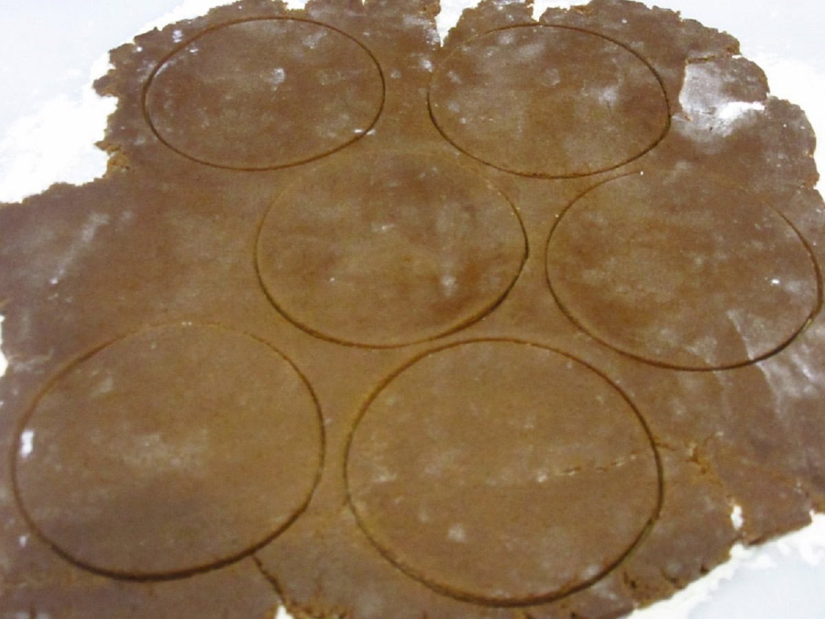 Circles cut out of gingerbread cookie dough.
