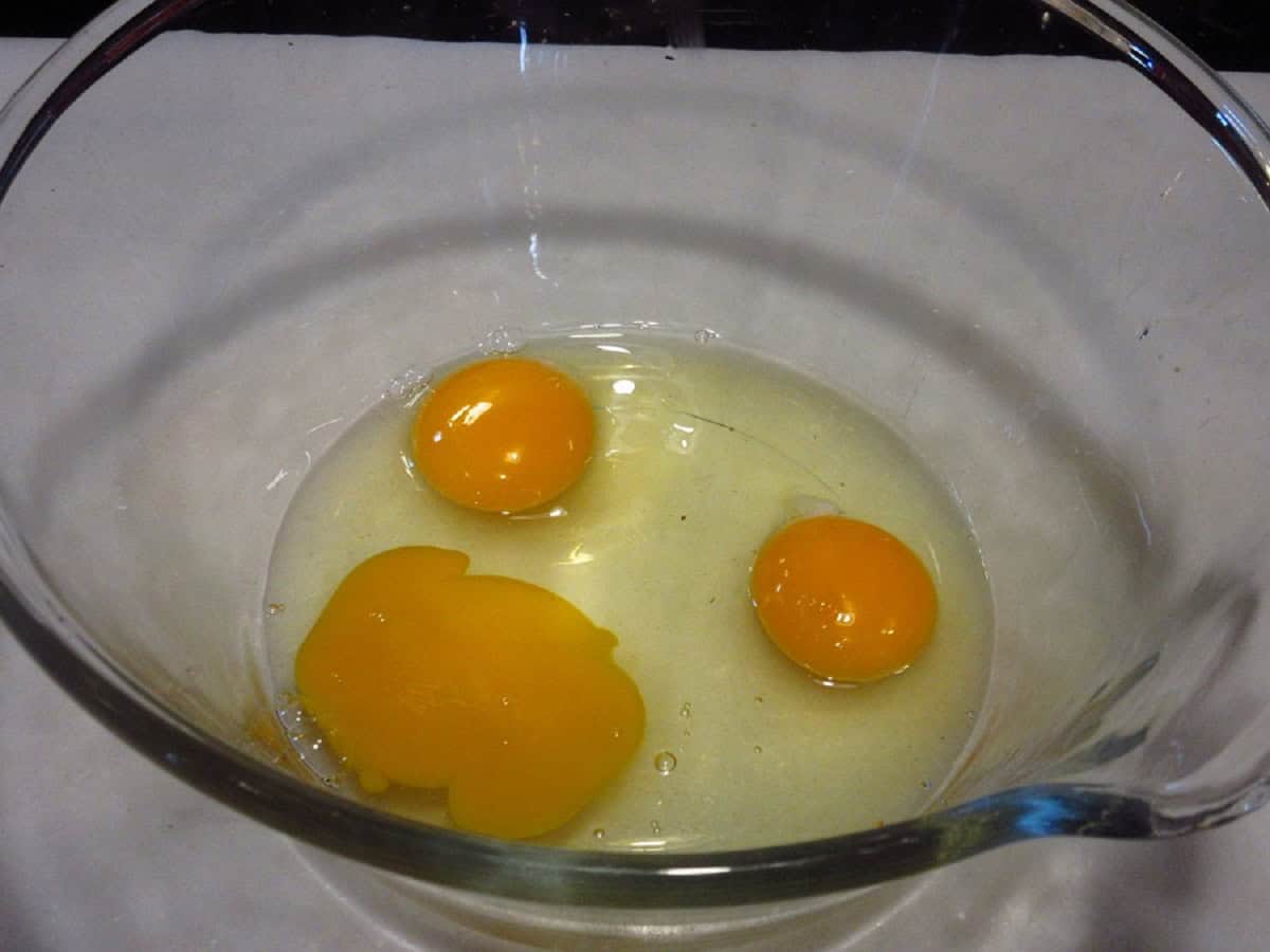 Three eggs in a glass bowl.
