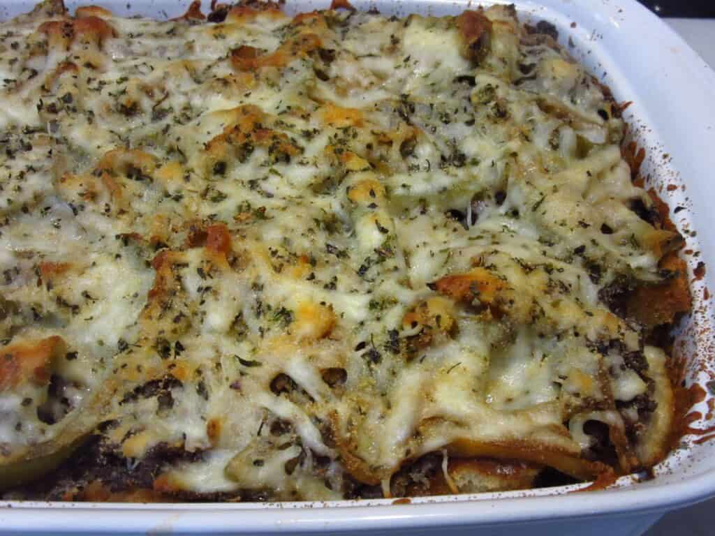Melted cheese on top of a baked Italian Beef Bread Pudding.