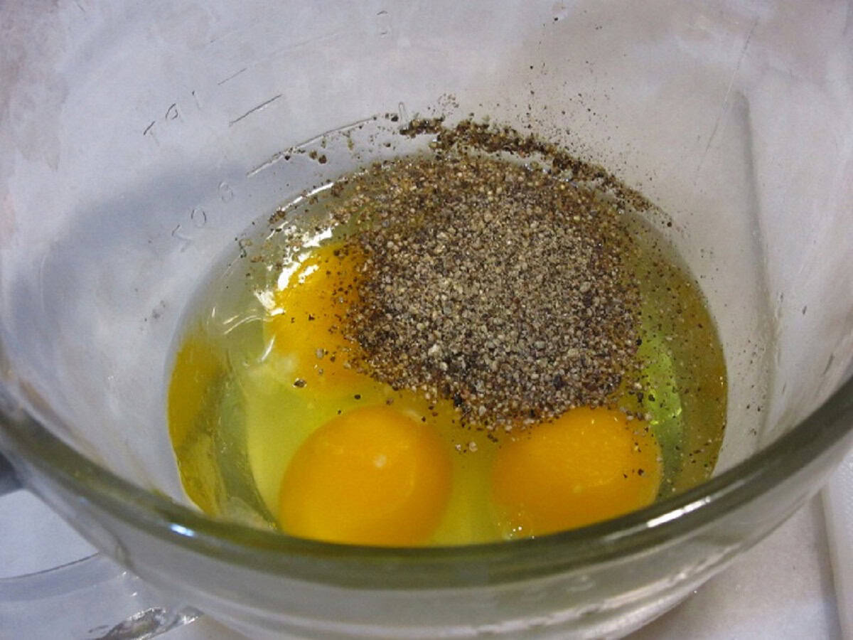 Eggs and pepper in a glass bowl.