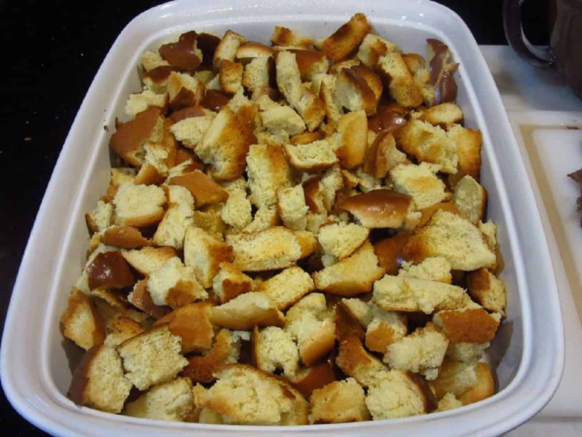 Toasted brioche bun pieces in a casserole dish.