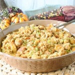 A round tan casserole dish filled with Hawaiian sweet roll stuffing.