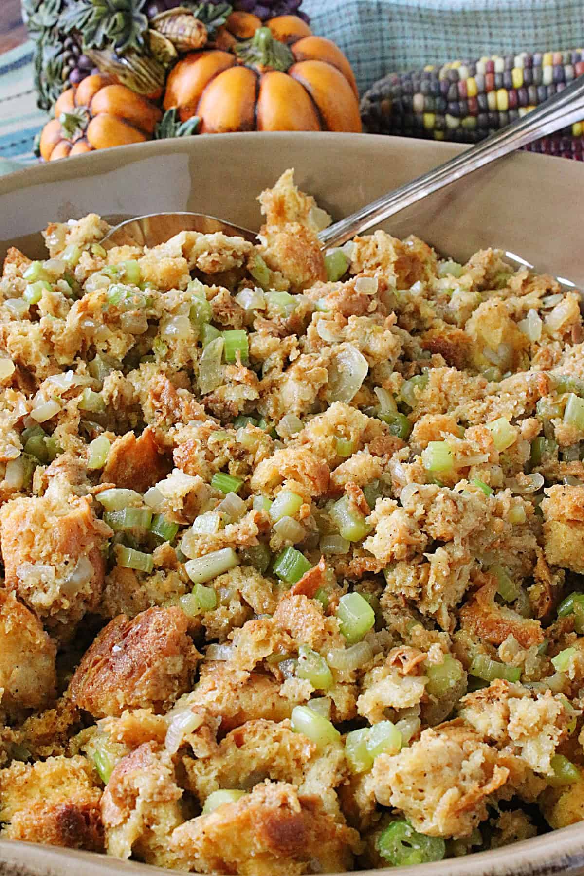 Sweet Hawaiian Roll Stuffing in a casserole dish with a spoon.