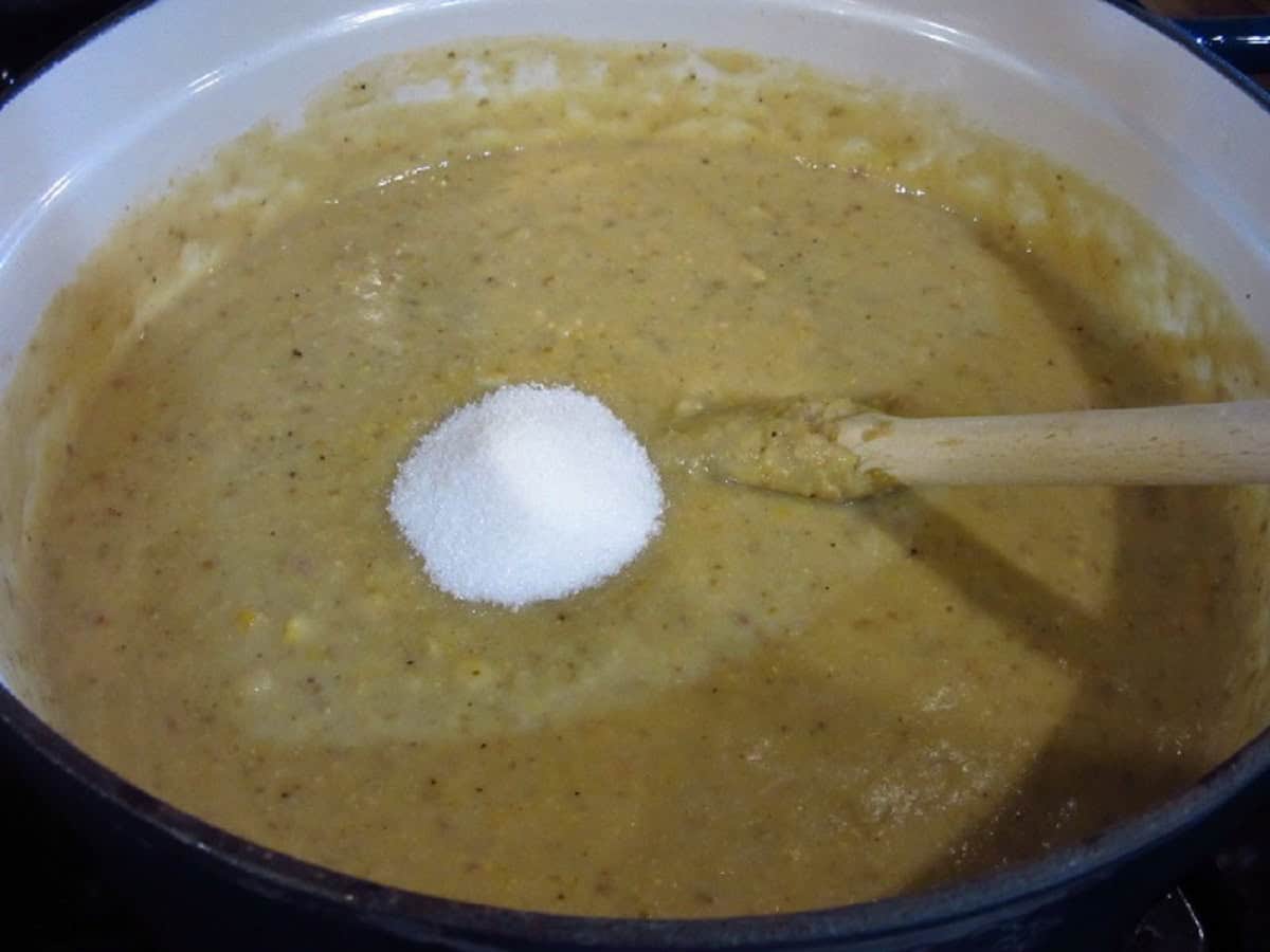 Sugar added to a pot of corn chowder.