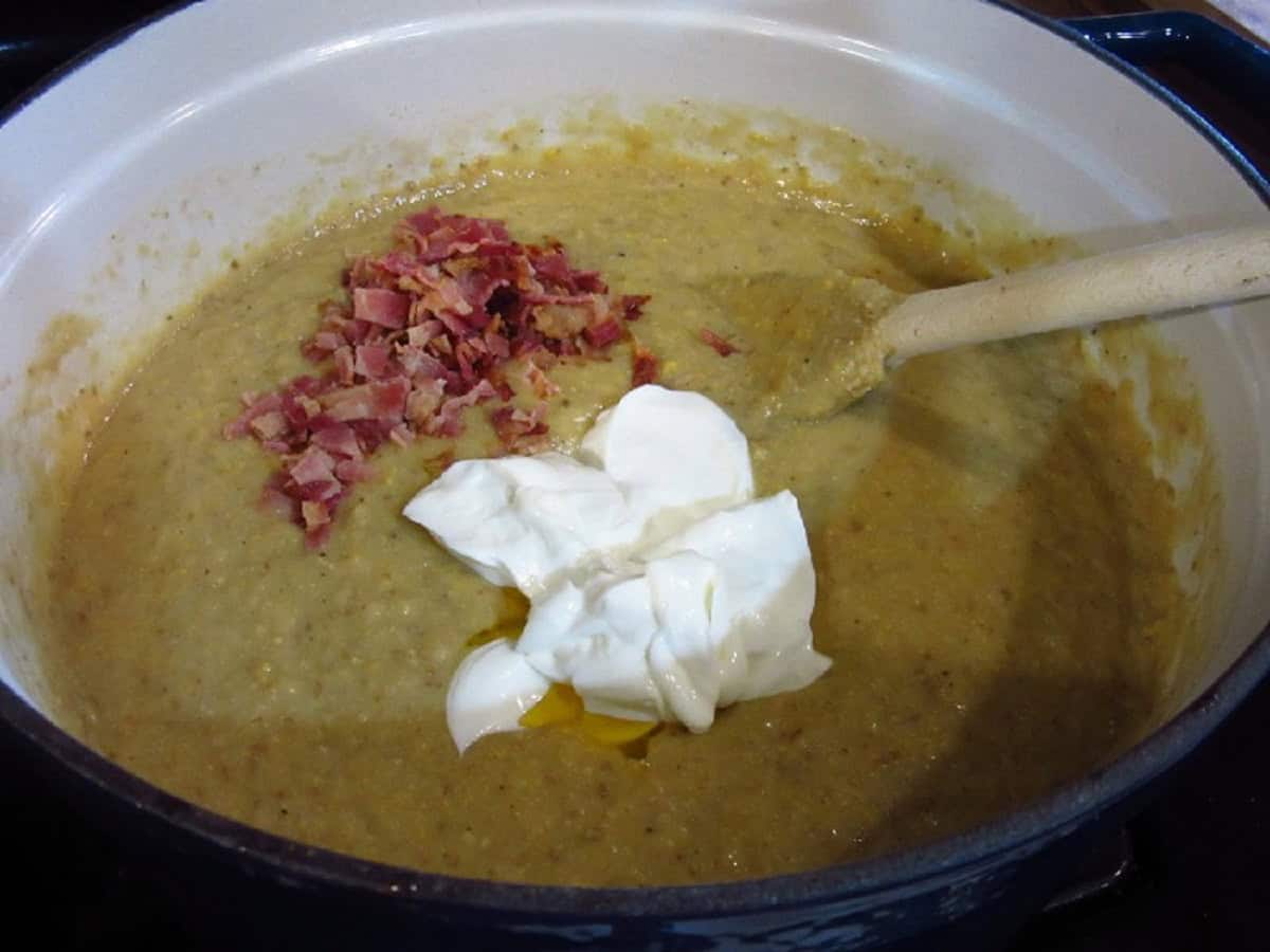 Sour cream and bacon in a Dutch oven with roasted corn and potato chowder.