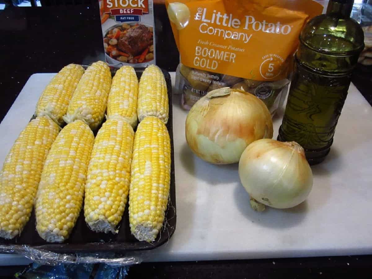 Corn, onions and potatoes on the countertop to make chowder.
