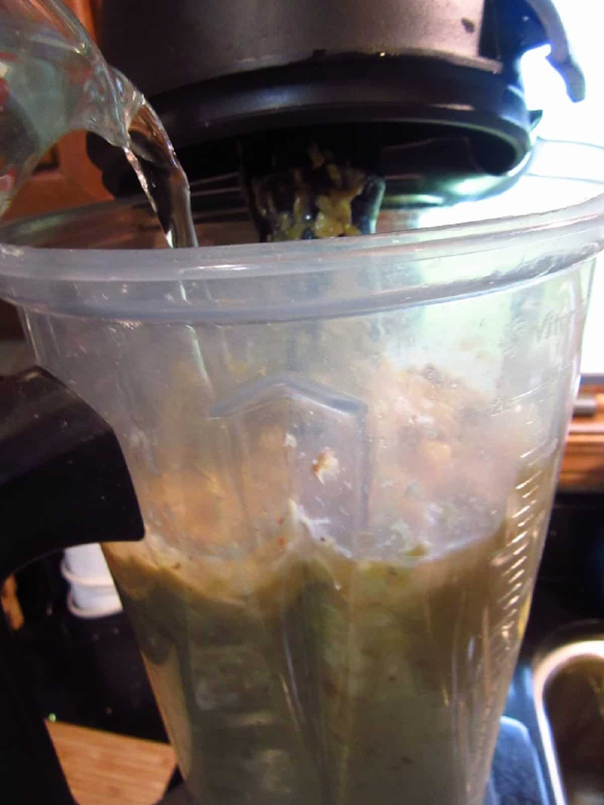 Water added to a blender of chowder.