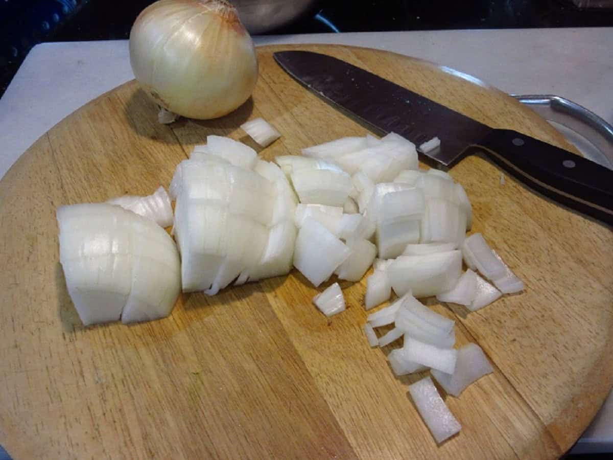 A chopped onion on a cutting board.