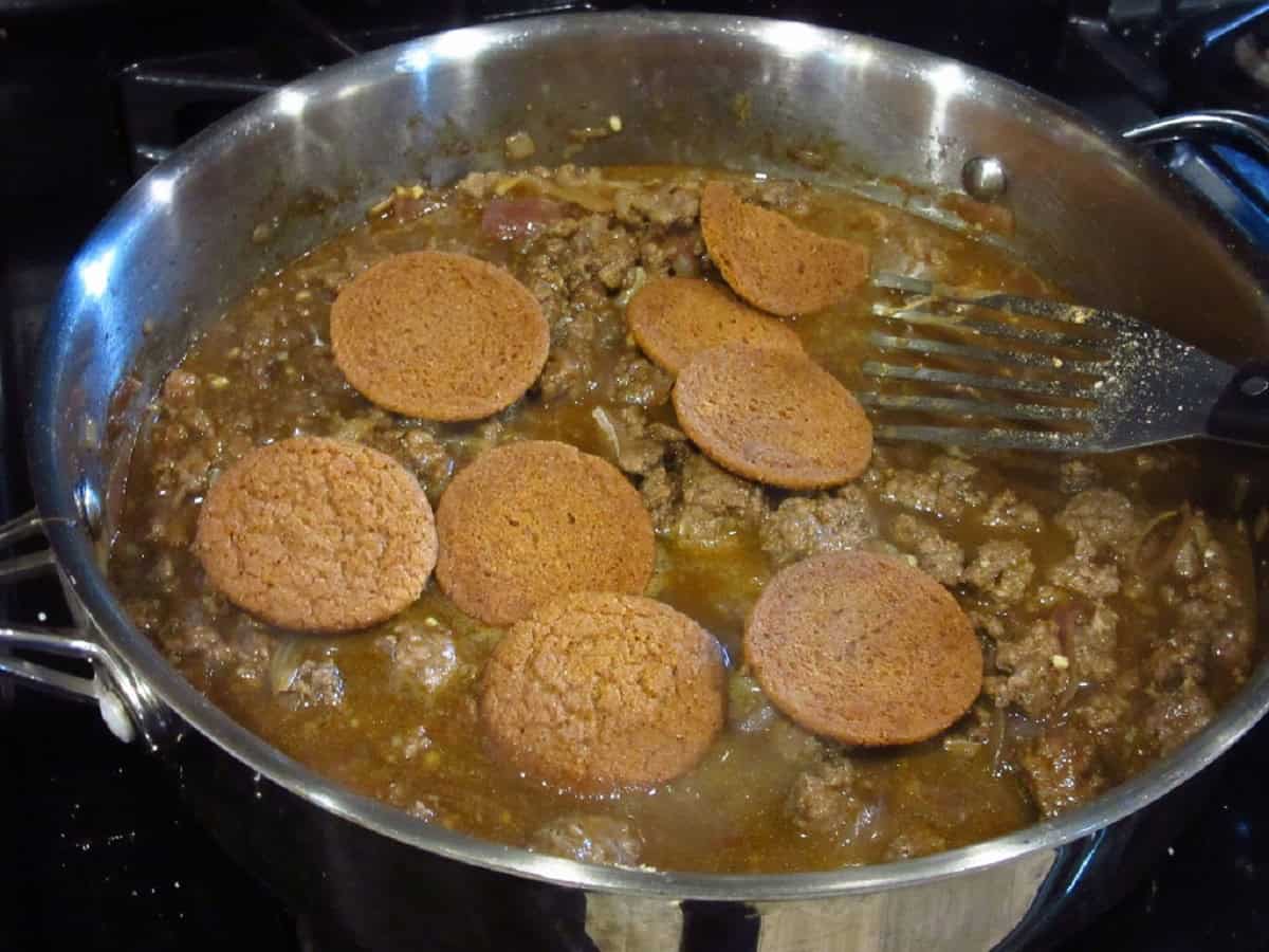 Ginger snap cookies in a large skillet with ground beef sauerbraten goulash.
