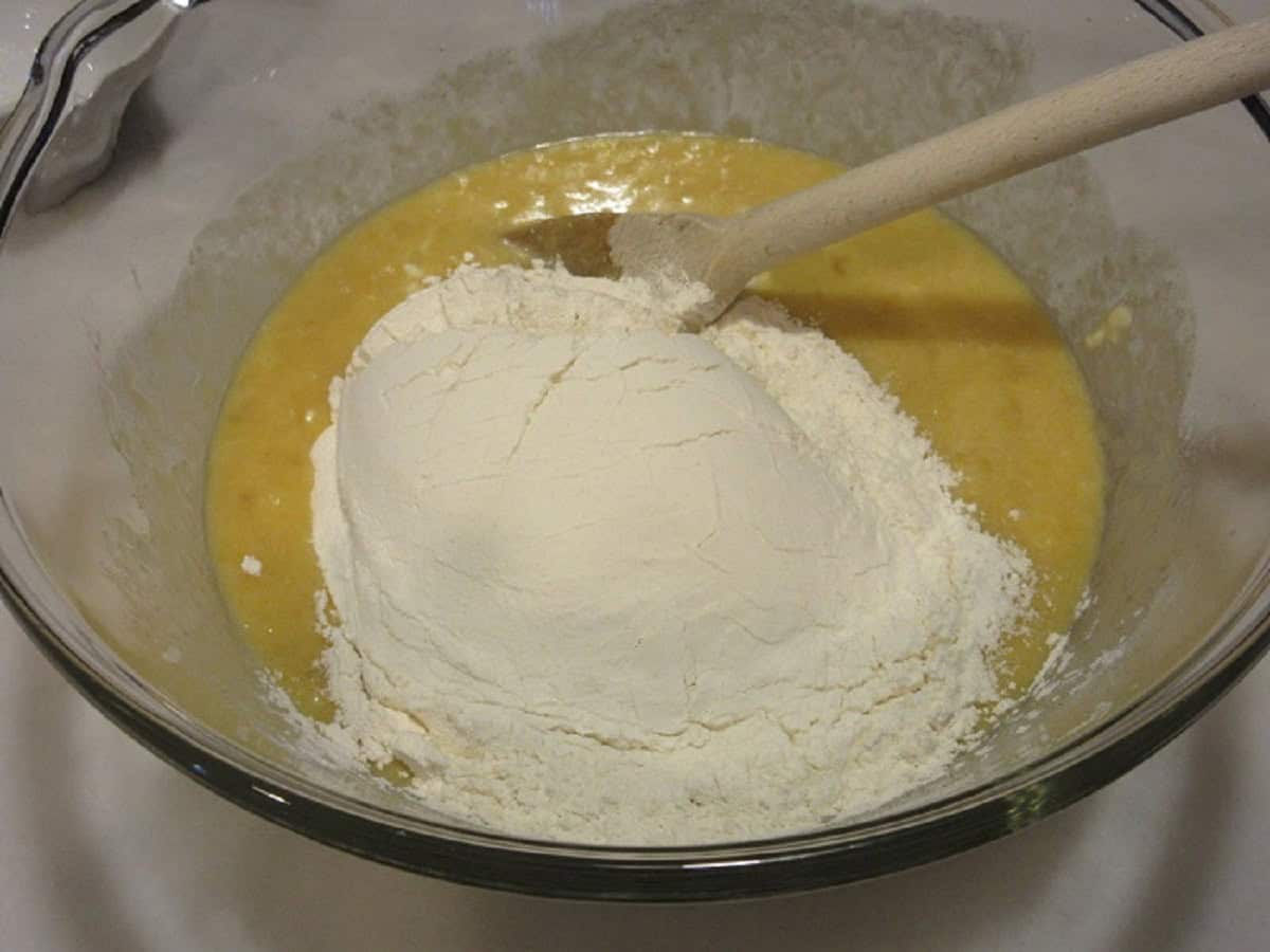 Flour in a bowl with a banana bread mixture.