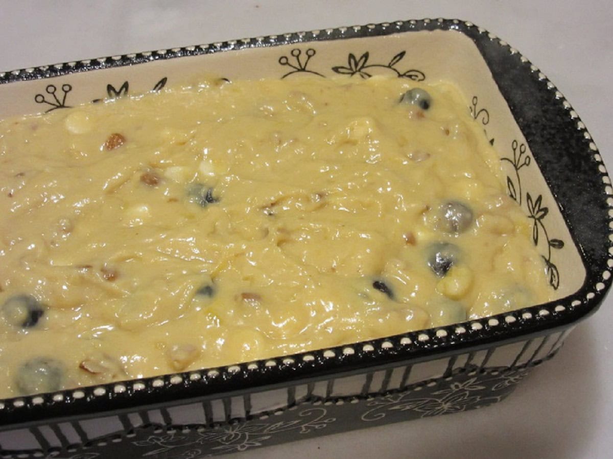 An unbaked Banana Blueberry Bread in a ceramic loaf pan.
