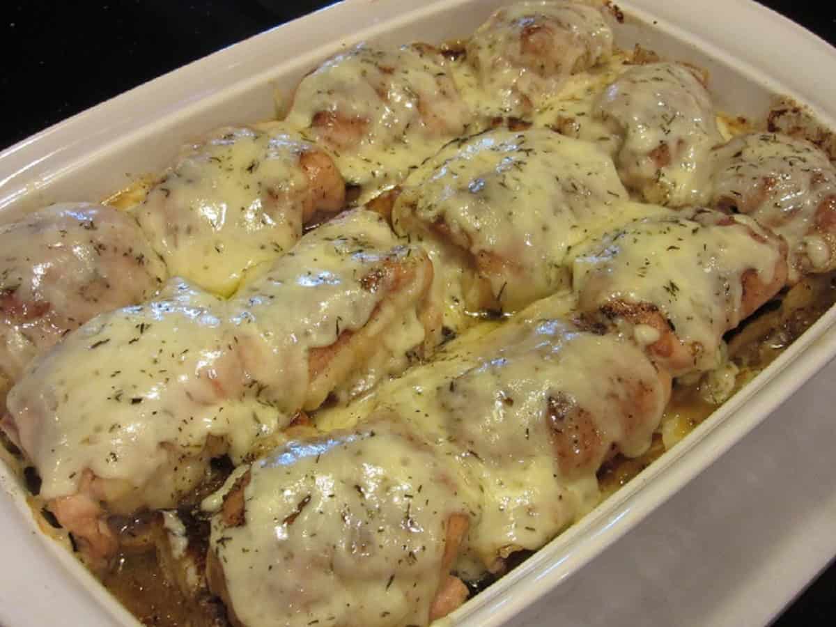 Melted cheese on top of French onion chicken thighs.