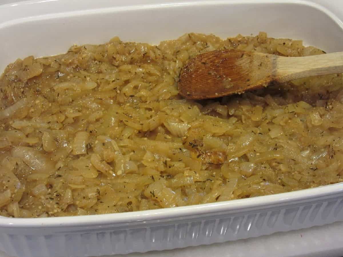 Caramelized onions in a white casserole dish.