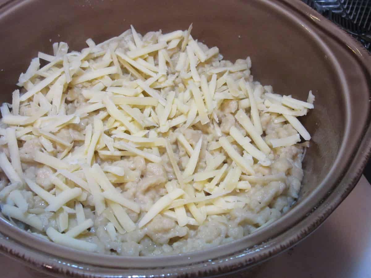 Shredded cheese on a casserole before baking.