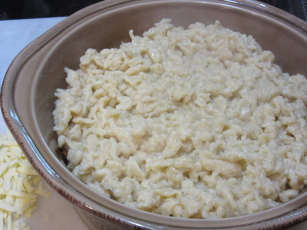 Wet spaetzle noodles in a casserole dish.